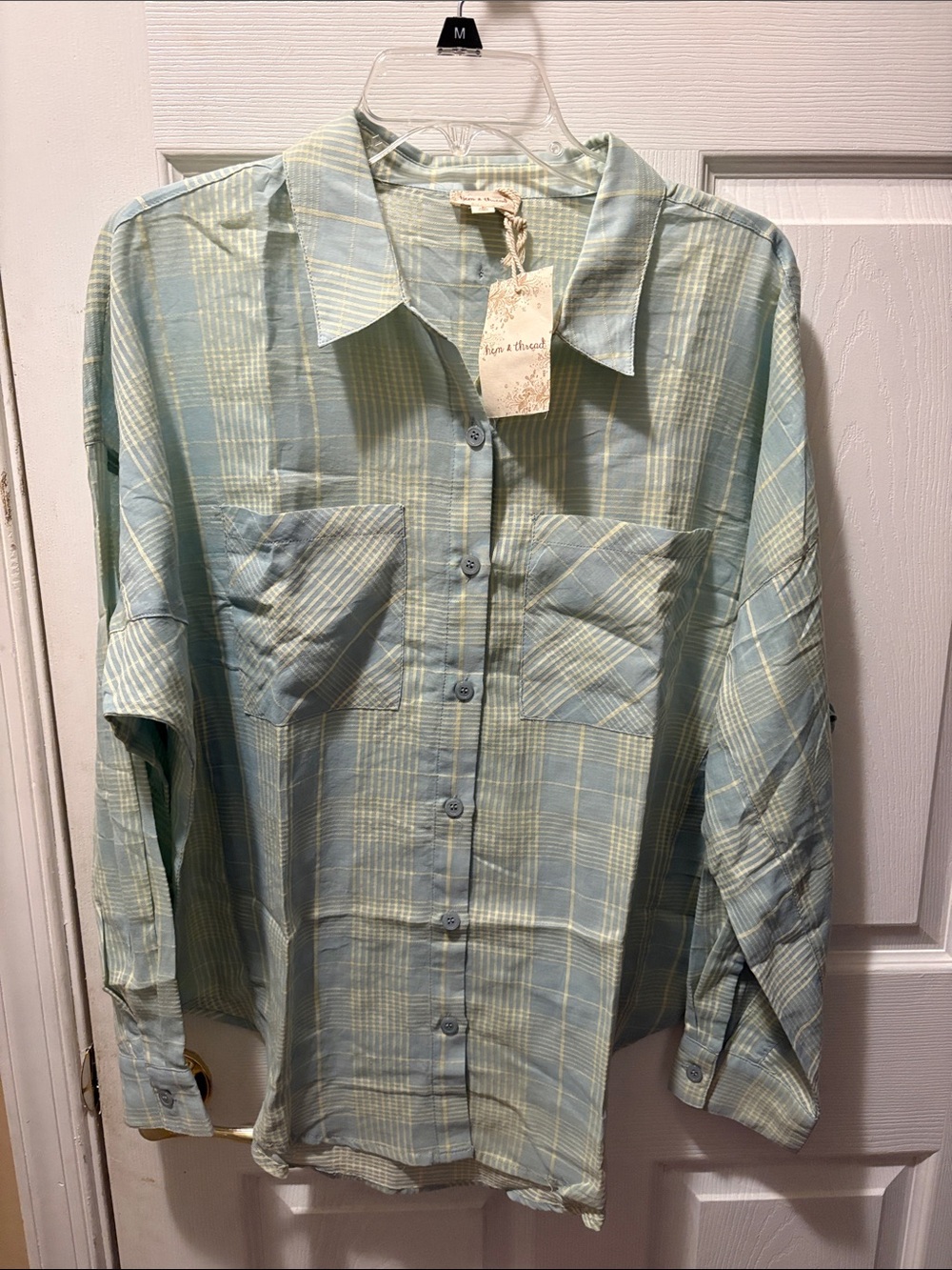 Hem and thread button down plaid shirt